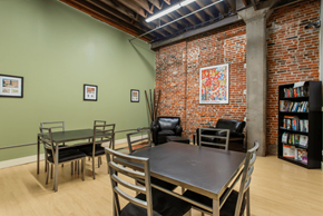St. Louis apartment for rent - a dining room with a table and chairs and a brick wall