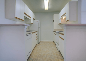 Blairsville apartment for rent - an empty kitchen with white cabinets and white appliances