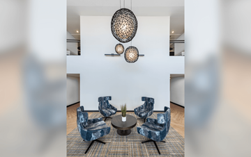 Denver apartment for rent - a living room with blue chairs and a round table
