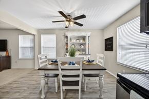 Arnold apartment for rent - A dining room with a table set for two and a ceiling fan.