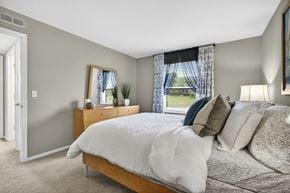 Arnold apartment for rent - A bedroom with a large bed and a window with curtains.