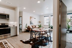 Denver apartment for rent - A modern kitchen with a dining table set for four.