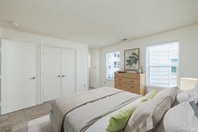 Hampton apartment for rent - A bedroom with a bed, dresser, and wardrobe.