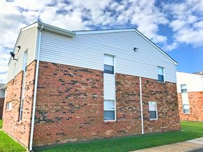 Hampton apartment for rent - the side of a brick building with white siding