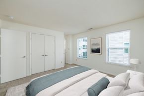Chesapeake apartment for rent - A bedroom with a large bed and a window with blinds.