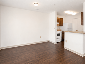 Richmond apartment for rent - A kitchen with white cabinets and a wooden floor.