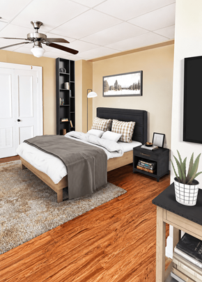 Little Rock apartment for rent - A bedroom with a bed, a ceiling fan, and a rug.