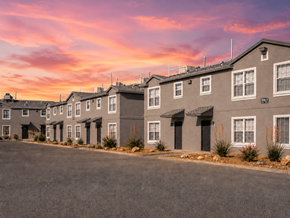 El Paso apartment for rent - A row of houses with a pink and purple sky in the background.