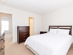 Ashland townhouse for rent - A bedroom with a large bed and a dresser.