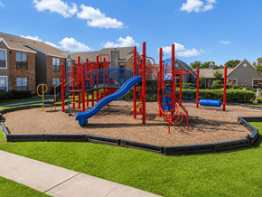 Houston townhouse for rent - A playground with a red and blue slide and a yellow circle on the ground.