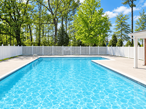 Richmond apartment for rent - A rectangular pool with a white fence around it.