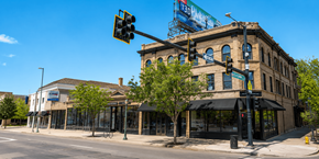 Denver apartment for rent - A street view of a city with a traffic light and a building with a sign that reads "The Standard".