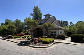 Sanford apartment for rent - a house with a driveway and landscaping in front of it