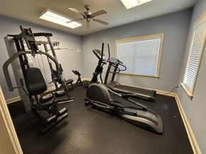 Sanford apartment for rent - the gym has plenty of exercise equipment and a ceiling fan