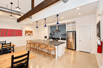 Haslet apartment for rent - A kitchen with a black stove top oven and a stainless steel refrigerator.