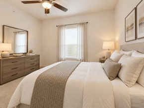 Haslet apartment for rent - A bedroom with a large bed and a ceiling fan.