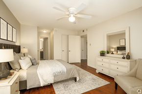 North Little Rock apartment for rent - A bedroom with a bed, dresser, mirror, and ceiling fan.