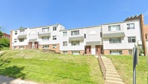 Omaha apartment for rent - A row of townhouses with a grassy front yard.