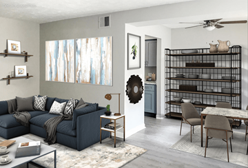 Omaha apartment for rent - A living room with a blue couch and a wreath on the wall.