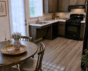 St. Louis townhouse for rent - A kitchen with a table and chairs in front of a window.