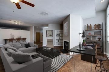 Memphis apartment for rent - A living room with a grey couch and a black and white rug.