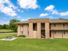 Bartlesville apartment for rent - A building with a red door and a balcony.