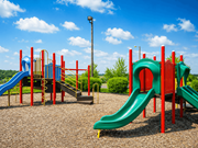 Hermitage apartment for rent - A playground with a green slide and a red and blue structure.