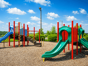 Hermitage apartment for rent - A playground with a green slide and a red and blue structure.