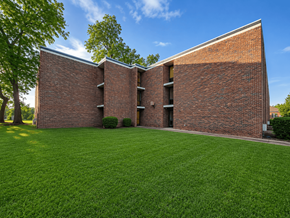Columbus apartment for rent - A red brick building with a green lawn in front.