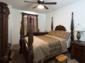 Dallas apartment for rent - a bedroom with a bed and a ceiling fan