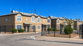 Anthony townhouse for rent - A row of houses with black fences in front.