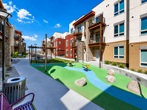 Denver apartment for rent - A playground with a blue and green surface and rocks.