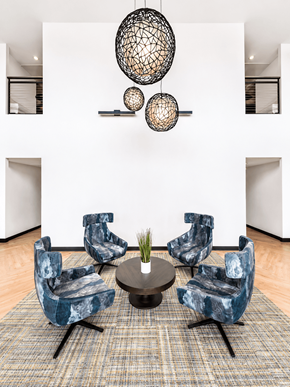 Denver apartment for rent - A living room with a white wall and a set of blue chairs.