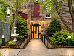 Petersburg apartment for rent - A brick building with a red window and a wooden door.