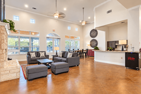 San Marcos townhouse for rent - A living room with a fireplace and a kitchen area in the background.