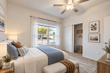 San Marcos townhouse for rent - A bedroom with a large bed and a ceiling fan.