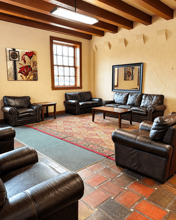 Little Rock apartment for rent - A living room with leather couches and a rug.