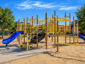 El Paso apartment for rent - A playground with a yellow structure and a blue slide.