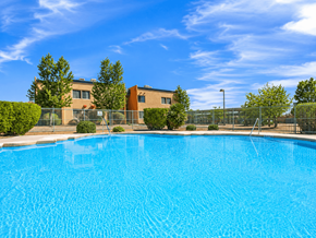 El Paso apartment for rent - A swimming pool in front of a building with a fence around it.