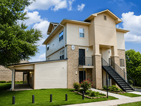 Shreveport townhouse for rent - A two-story house with a balcony and a staircase leading to the second floor.