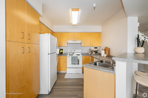 Denver apartment for rent - A kitchen with wooden cabinets and a white refrigerator.