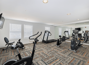 Denver apartment for rent - A gym with a variety of exercise equipment including treadmills, stationary bikes, and elliptical machines.