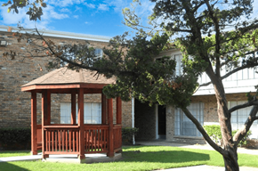 Houston apartment for rent - a small screened porch in front of a brick house