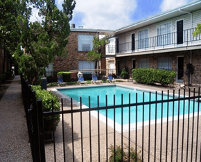 Houston apartment for rent - a swimming pool in front of an apartment building