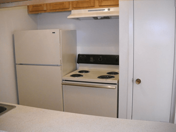 Houston apartment for rent - A white refrigerator and oven are in a kitchen.