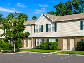 Hebron townhouse for rent - A building with a parking lot in front of it.