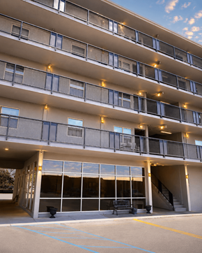 Meridian apartment for rent - A large building with a lot of windows and lights on the balcony.