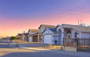 Horizon apartment for rent - a row of houses on a street at sunset