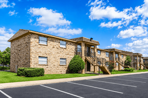 Jacksonville apartment for rent - A large stone building with a parking lot in front.
