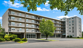Meridian apartment for rent - A large apartment building with a parking lot in front.